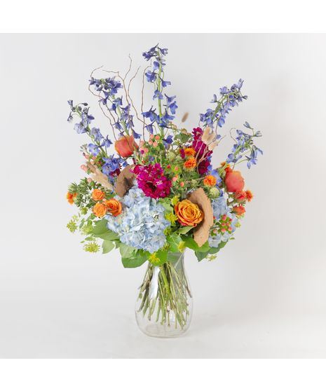 Wooded Stream is a striking fall arrangement designed in our elegant Jordan vase, evoking the vibrant beauty of nature in autumn. 