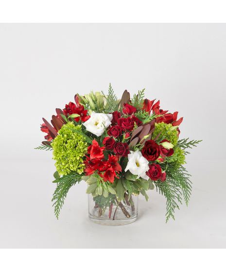 North Pole Christmas brings the magic of the season to life with a vibrant mix of festive blooms and lush textures.