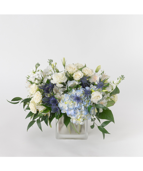 Our Serene Light arrangement celebrates Hanukkah with an elegant blend of cool tones and soft textures