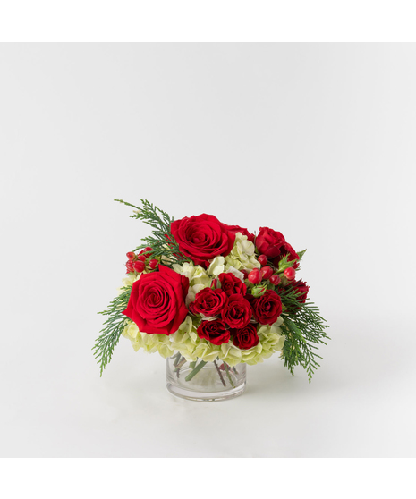Bring the warmth of the season to your home with our Cozy Christmas arrangement. 