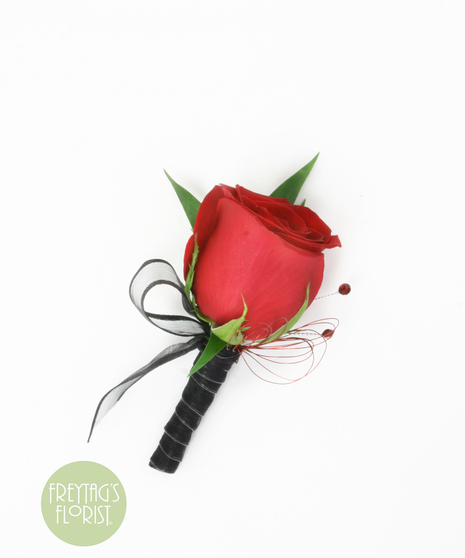 This simple rose boutonniere includes a rose bloom, Italian Ruscus green accents, and black ribbon.