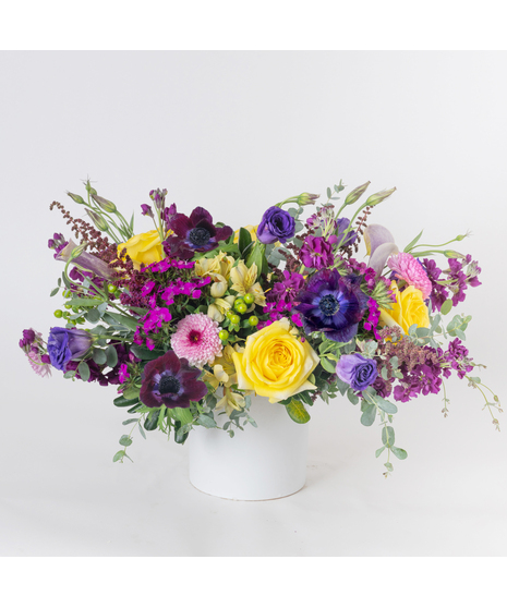 Midnight Moonlight is a stunning, garden-style floral arrangement designed to captivate with rich color and romantic texture