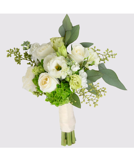 White Roses hand-tied bouquet includes white hydrangea, white medium stem roses, white phalaenopsis blooms, and seeded eucalyptus. 