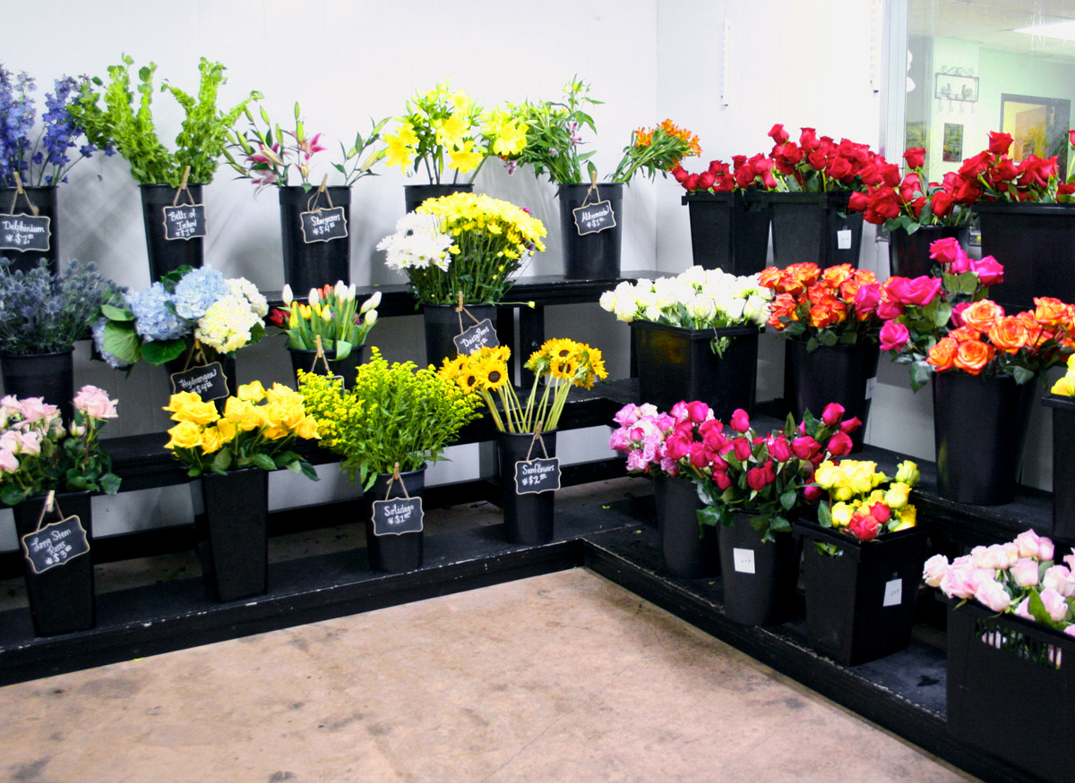 A wide range of colorful floral arrangements, awaiting their new home